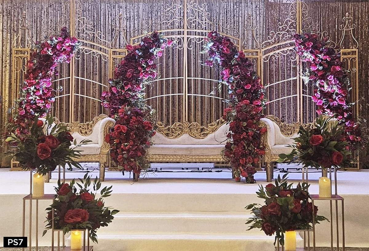Jewel-tone floral stage with gold columns