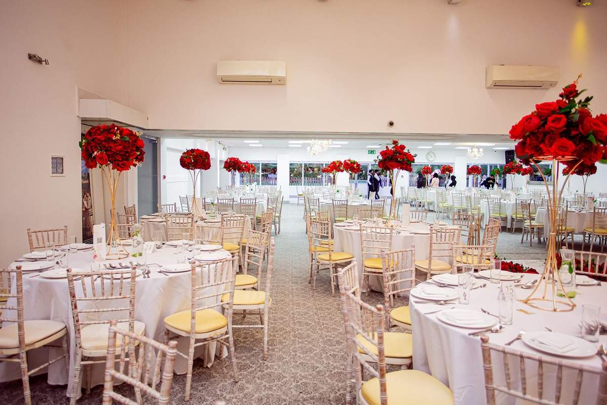 Hall tables with tall red rose centrepieces