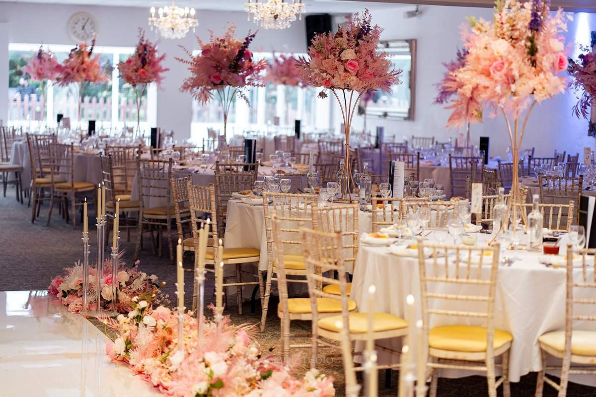 Pink tall floral centrepieces across the banquet floor