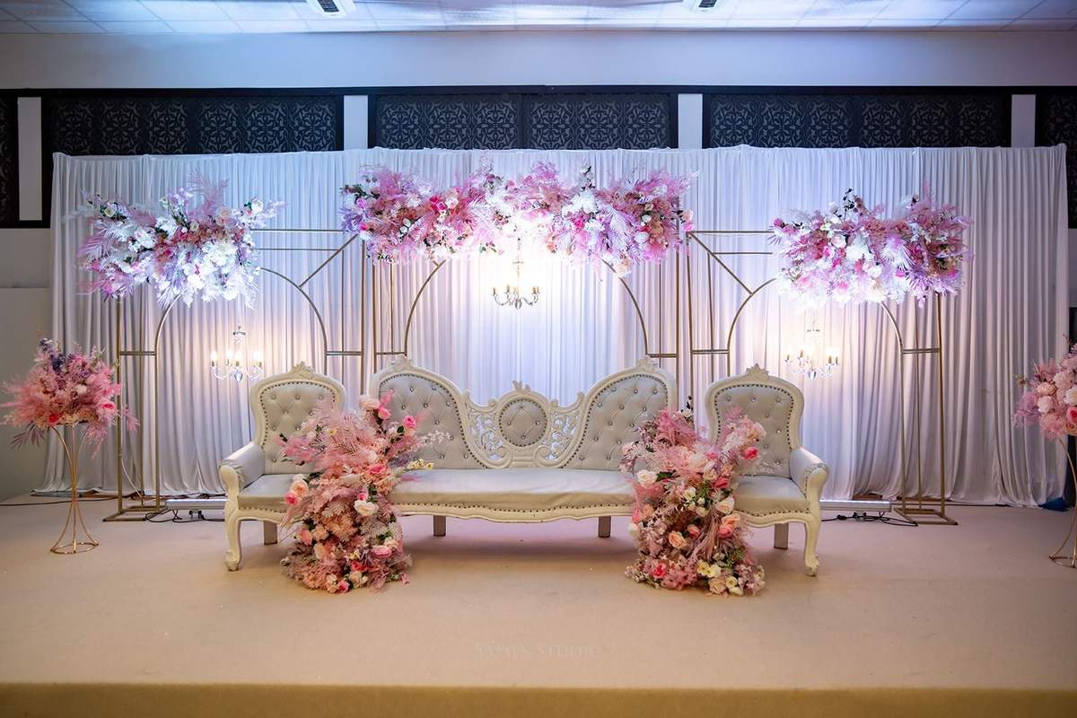 Soft pink stage lighting with white sofa seating