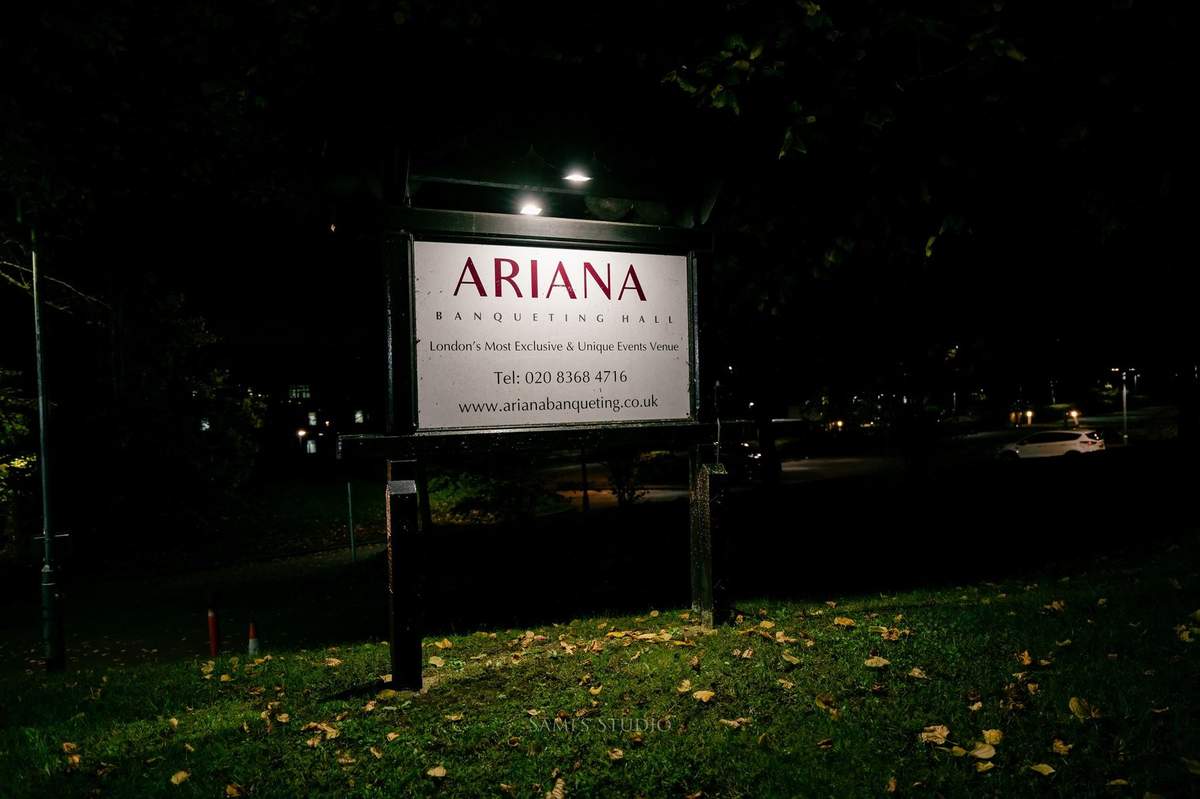 Ariana Banqueting Hall roadside sign at night