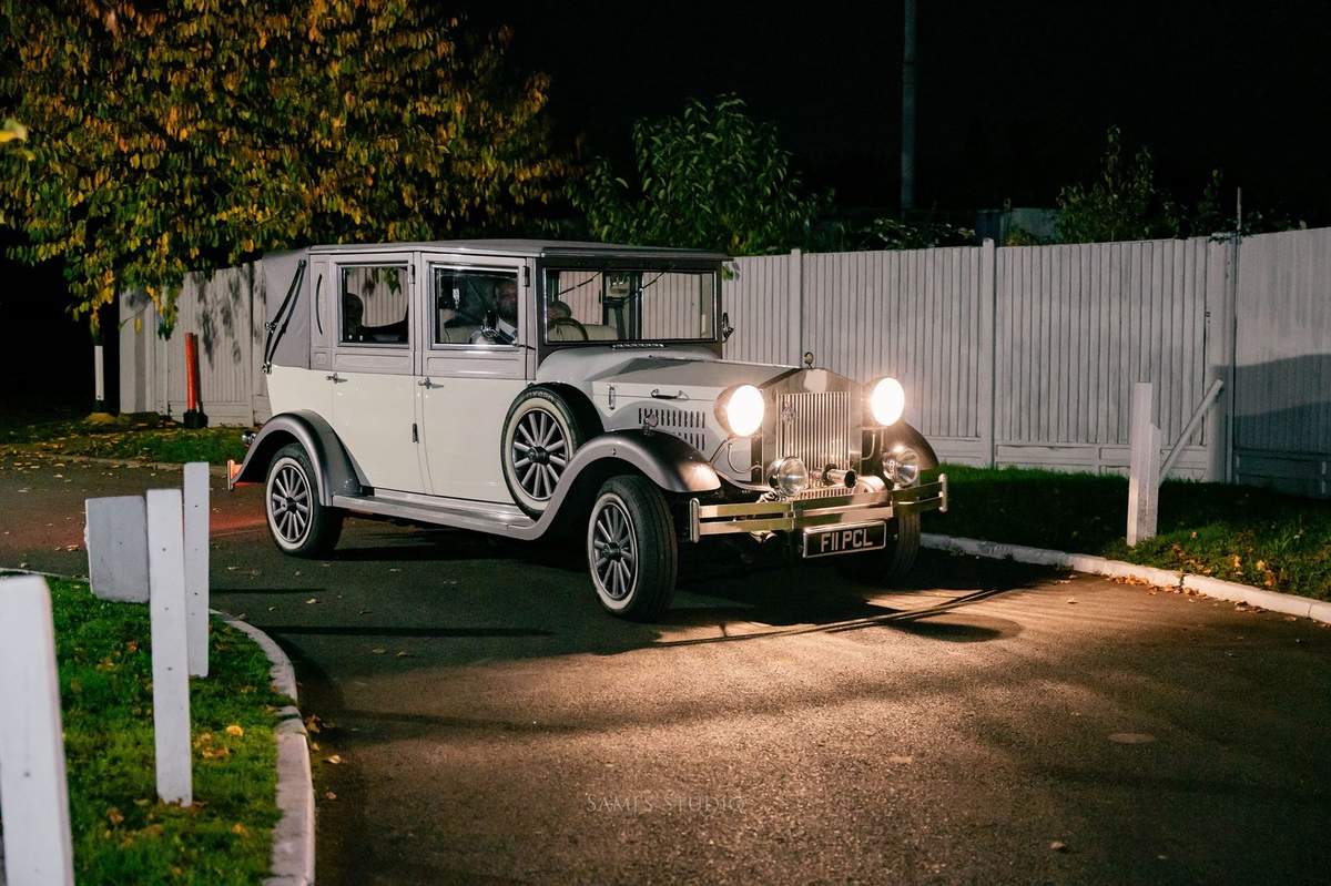 Vintage white wedding car at the hall entrance