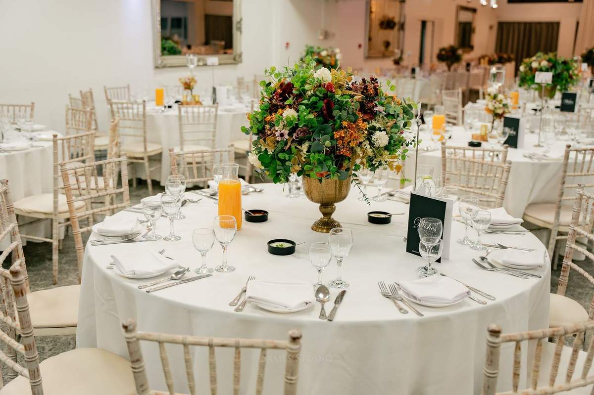 Table setting with a brass vase and seasonal florals