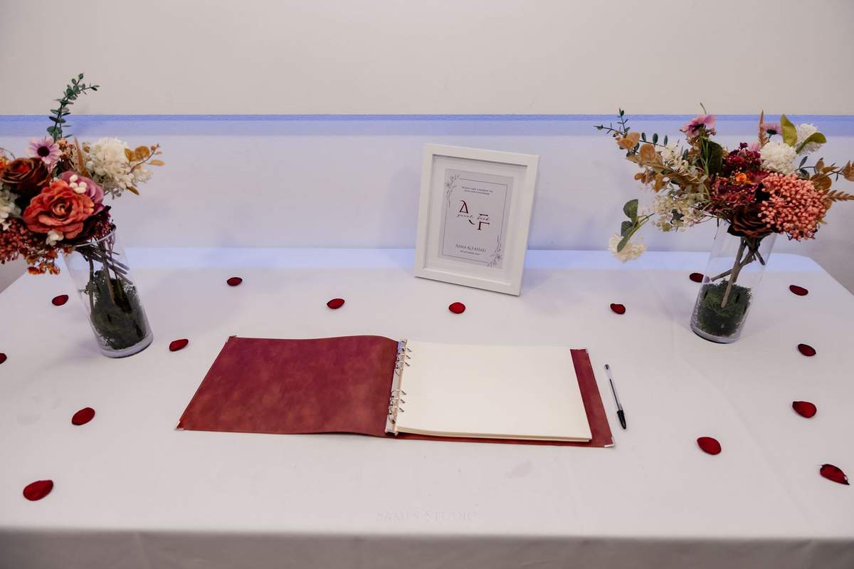 Signing table with rose petals and the guest book